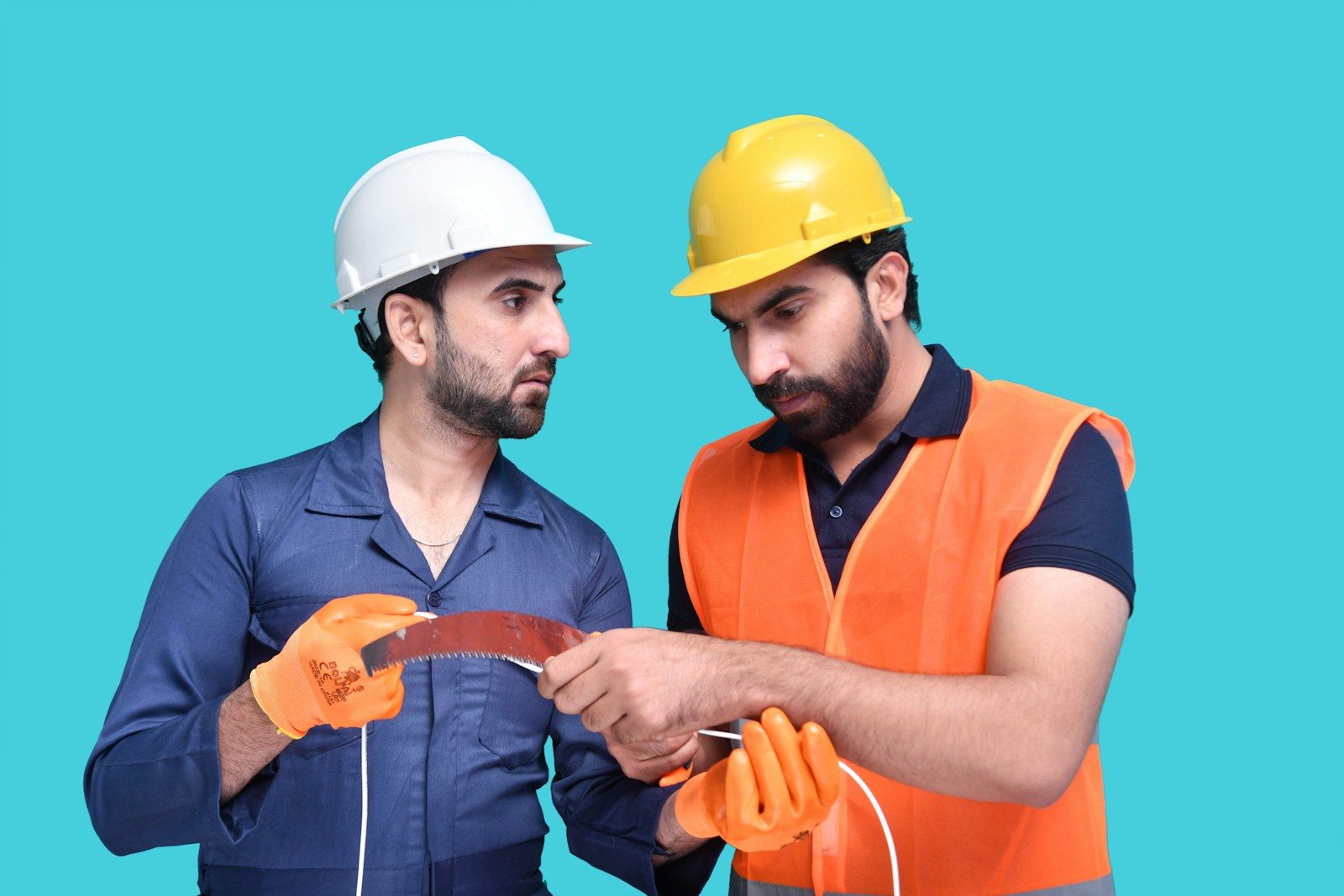 a couple of men wearing hard hats